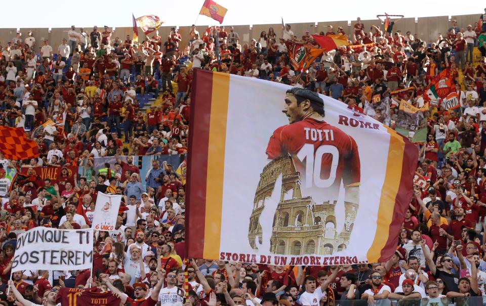 Roma fans hold aloft huge banner of Francesco Totti above famous Coliseum 