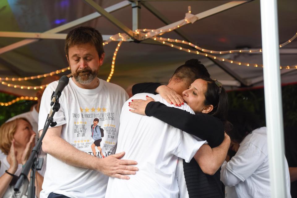  Martyn's mum hugs his friend on stage during the emotional vigil tonight