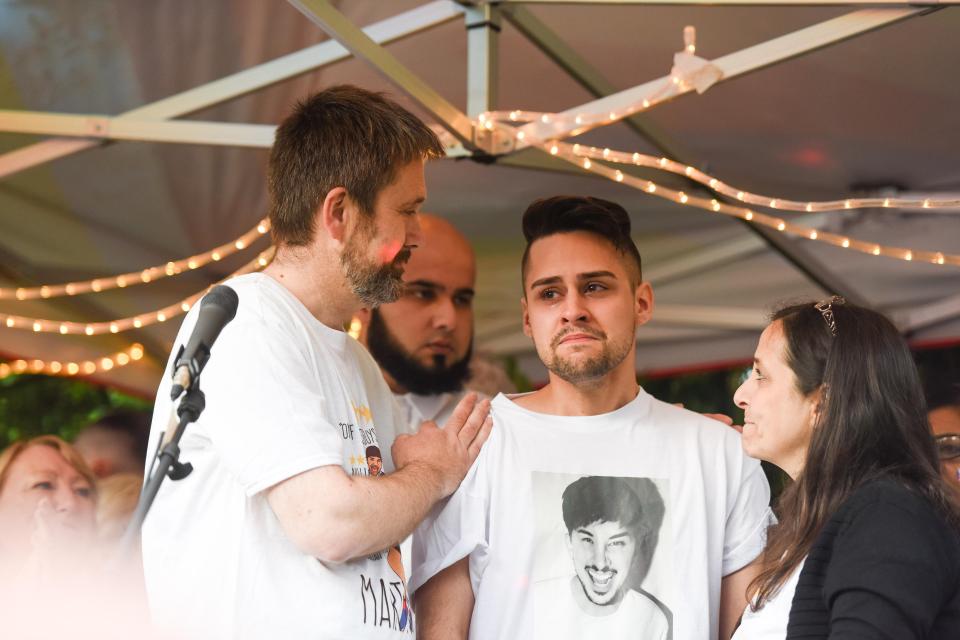  One of Martyn's friends is comforted by his stepfather at the vigil