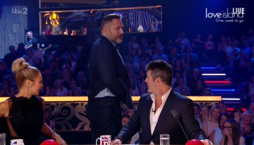  David got up and moved towards Simon when he correctly picked him as the judge with the tattoo