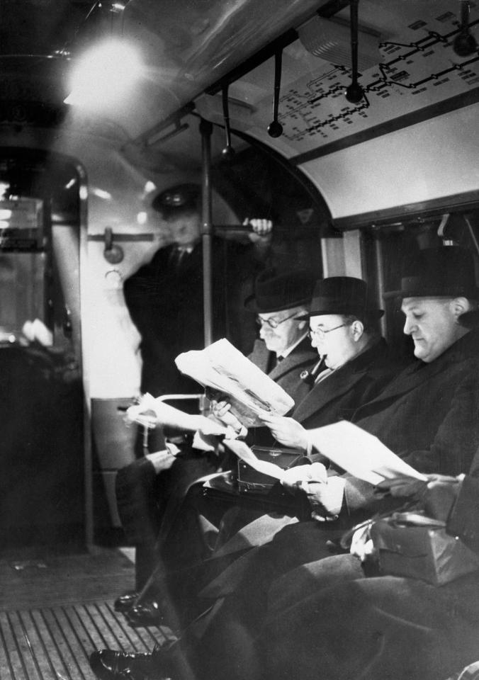  Travellers reading by the light of new lamps installed in the London subways in 1940. The lights provided full peace-time light while the trains were in tunnels, then subdued during air raids