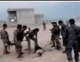  A suspected ISIS fighter is beaten as he lies on the ground