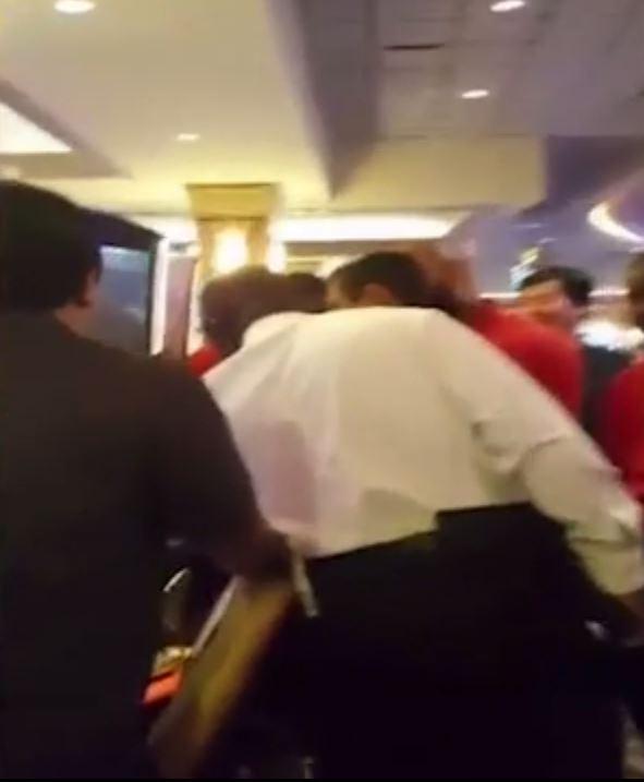  Casino officials and bystanders gather around Katrina's machine after she hit the jackpot