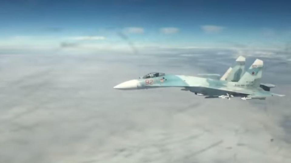  The Russian Su-27 fighter jet is seen approaching the US bomber on its starboard side