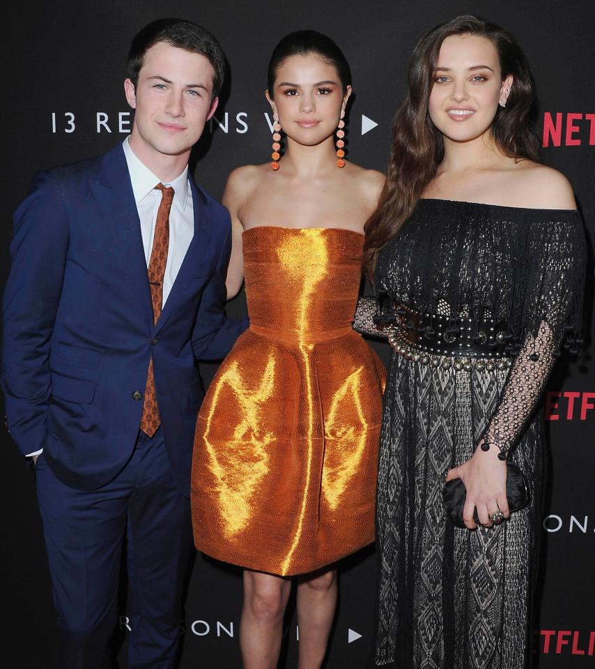  Selena Gomez with the show's stars Dylan Minnette and Katherine Langford. Supporters of the series say it gives families a chance to discuss difficult topics like rape, bullying, slut-shaming, drink driving and suicide