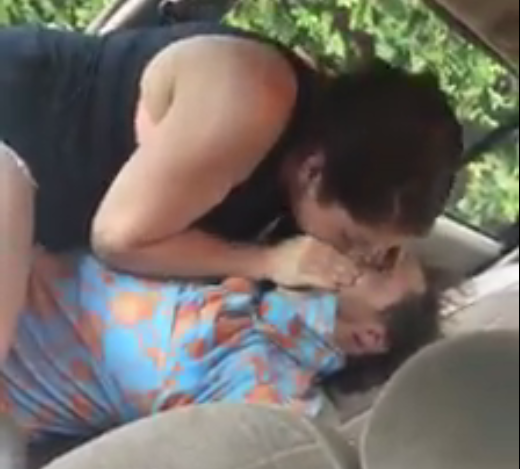  She gives him the kiss of life as he lies unconscious in the car