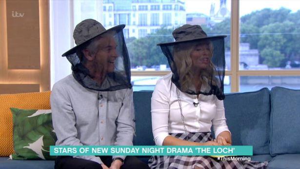  Phillip and Holly put on mosquito net hats to show their support for the cast of The Loch who've been battling the insects