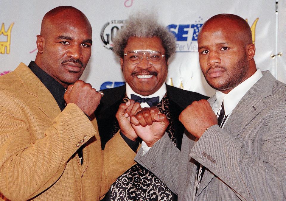  Evander Holyfield stands with promoter Don King and fellow fighter Michael Moorer ahead of their fight in 1997