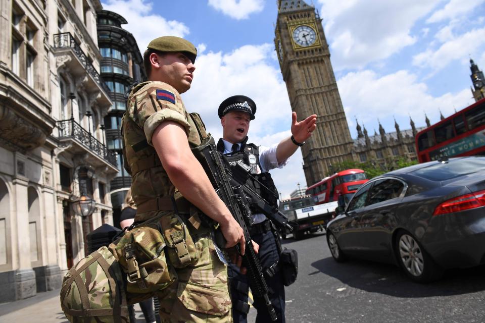  A soldier and an armed cop patrol near Parliament after the Manchester bombing