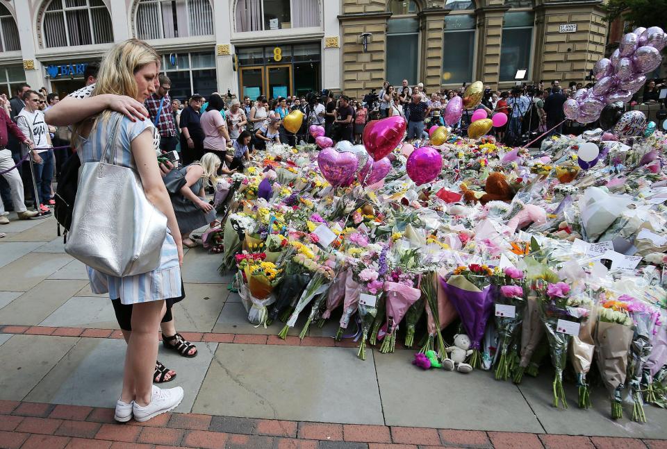  People paid their respects and laid flowers at a memorial for the victims of the Manchester bombing at St Ann's Square, near Manchester Arena