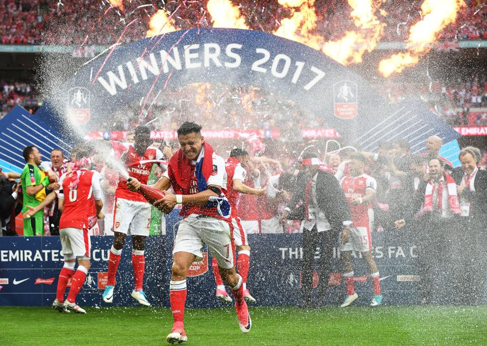 Alexis Sanchez celebrates winning the FA Cup last month in what could have been his final game for Arsenal