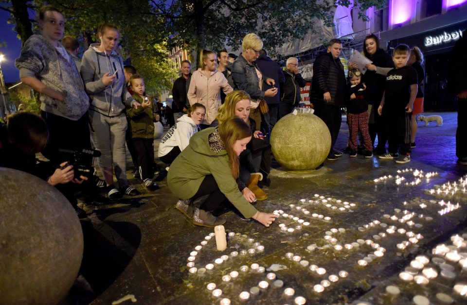  People leave messages of peace with stones in St Anne's Square