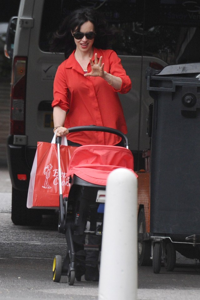 Sally pushes one of the twins along street in North London