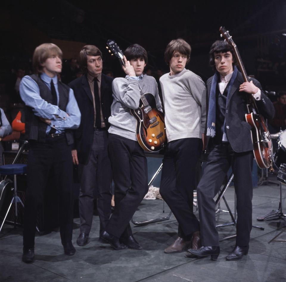  Here they can be seen on stage at the Mod Ball in 1964 with Brian Jones (far left) in charge of the creative direction