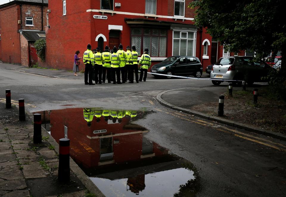  Police stand in front of a cordon in Rusholme