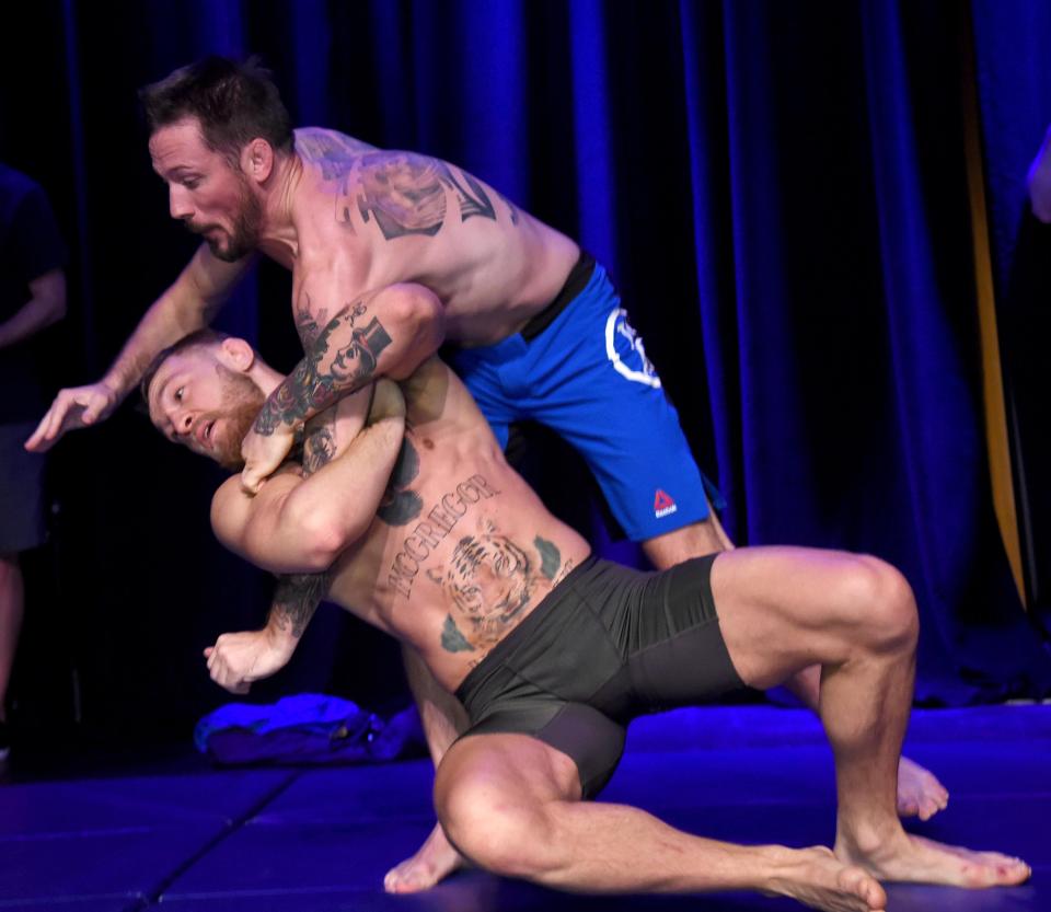 Conor McGregor spars with head coach John Kavanagh during an open session