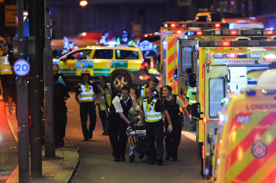  Police officers and members of the emergency services attend to a person injured in a terror attack on London Bridge on Saturday night