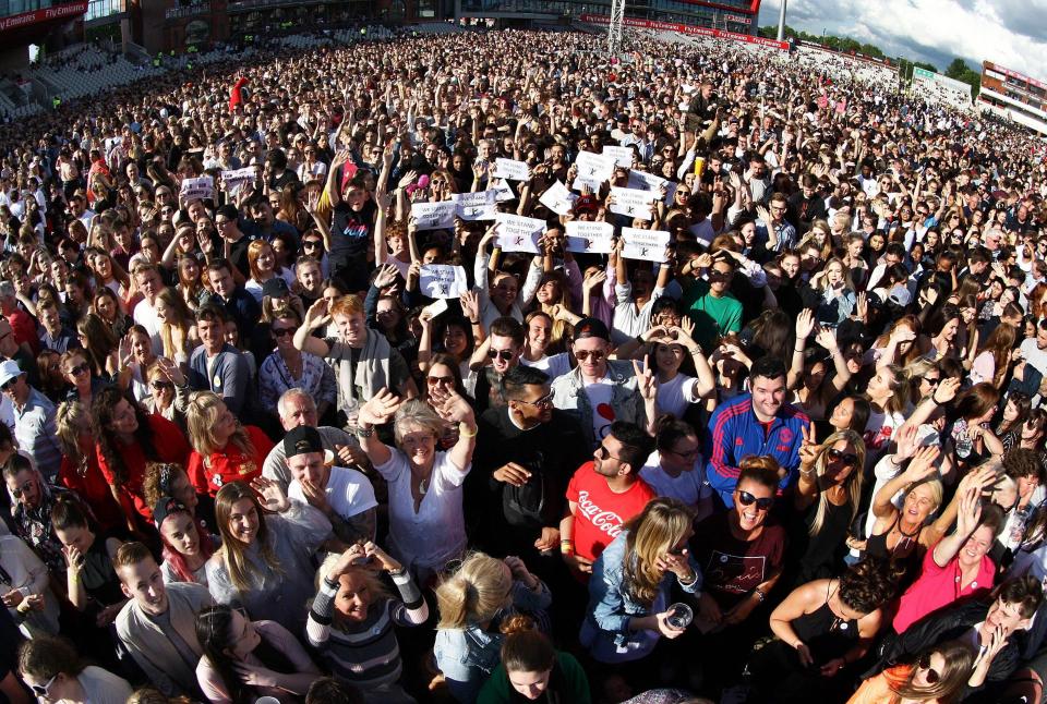 The crowd wave their hands in the air while enjoying the star studded line-up