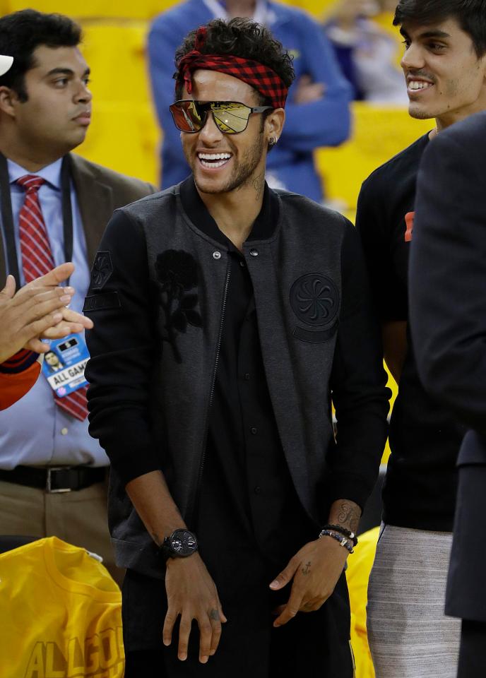  Neymar flashes a trademark smile courtside