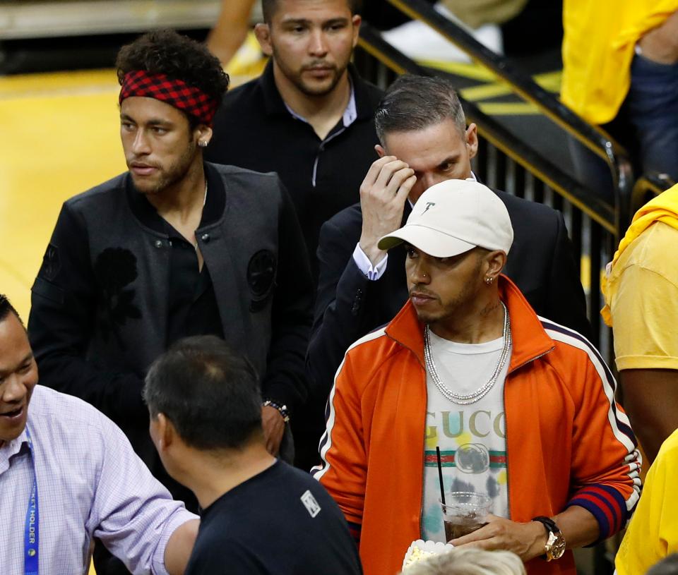  Lewis Hamilton stood out in a bright orange jacket