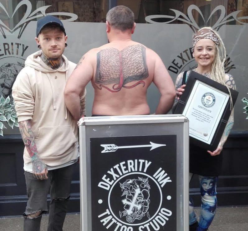  Mark poses outside Dexterity Ink in Wrexham where he had the record-breaking design done