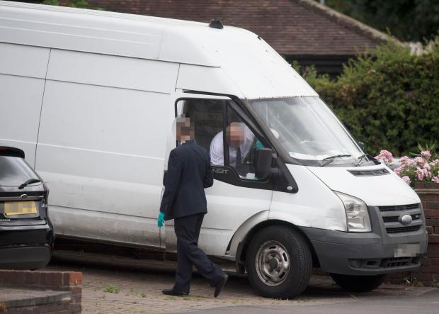 Undercover police officers inspect the Ford Transit van