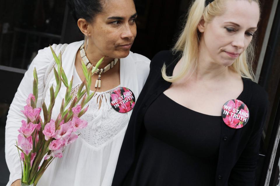  Lili Bernard (L), who was allegedly assaulted by Bill Cosby, looks at her friend Caroline Heldman as they leave the Courthouse