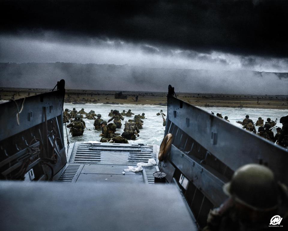  Allied troops wade on to the shore at Normandy off the ramp of a US Coast Guard landing craft into heavy machine-gun fire from German coastal defence forces.  A total of 156,000 troops landed on the beaches