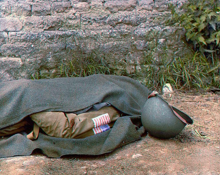  A blanket covers body of a US paratrooper killed in action in the days following the Allied invasion. The fallen soldier was found near St Mere-Eglise, a commune in Normandy