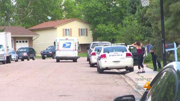  Emergency vehicles fill the road outside the home in Colorado, USA