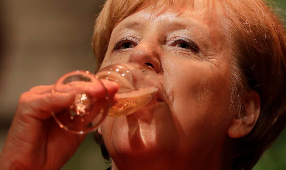  EU leaders such as Angela Merkel, pictured drinking champagne tonight, could win a softer Brexit as a result of the hung parliament