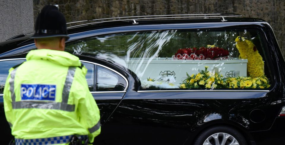  A police officer watches on as Courtney's coffin arrives at Saltwell Crematorium in Gateshead