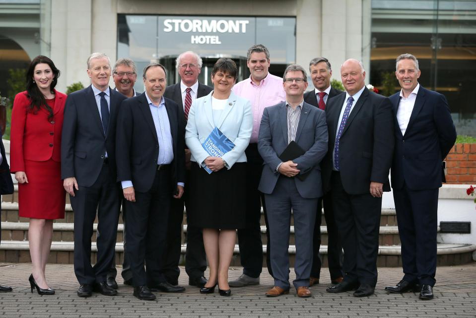 Flanked by her members of Parliament, Democratic Unionist Party (DUP) leader, and former Northern Ireland First Minister, Arlene Foster, poses for a photograph outside the Stormont Hotel in Belfast, Northern Ireland