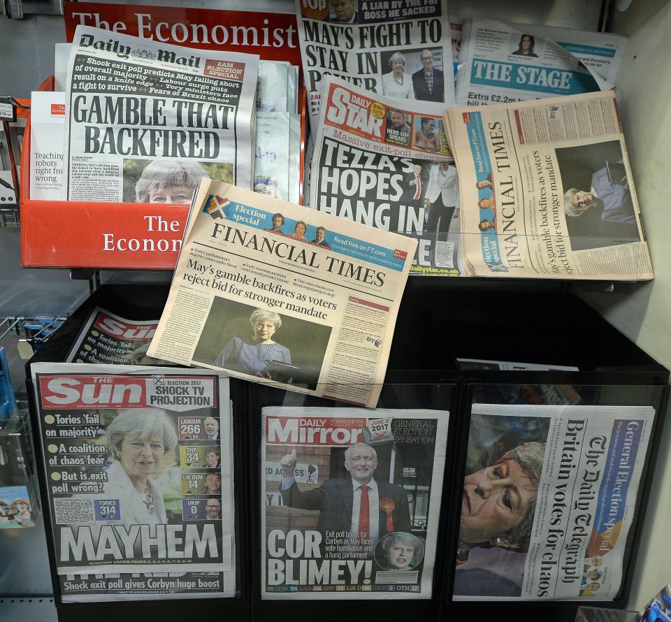 British General election headlines and placards of British newspapers on the news stand at Victoria Station in London