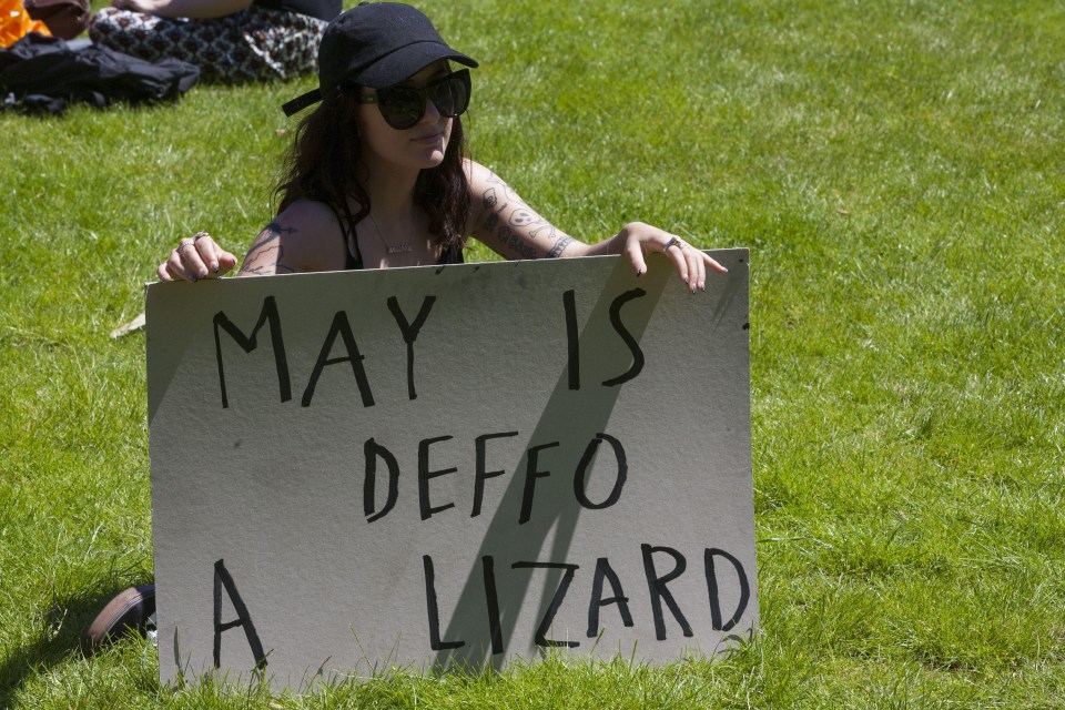 One of the signs held up during the protests stated May was 'deffo a lizard'