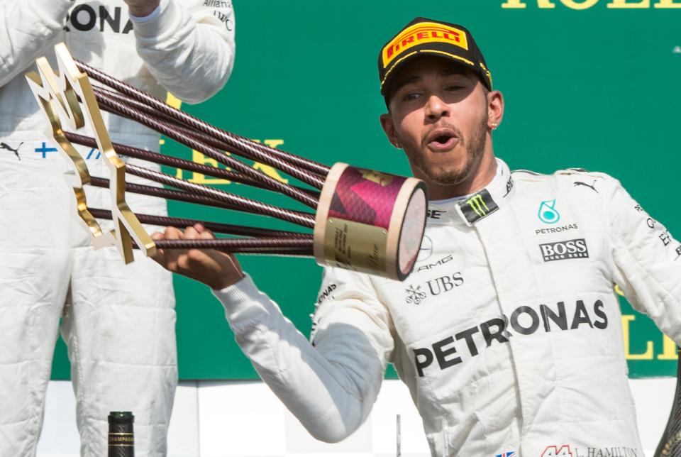 Lewis Hamilton poses with his trophy after winning the Canada GP