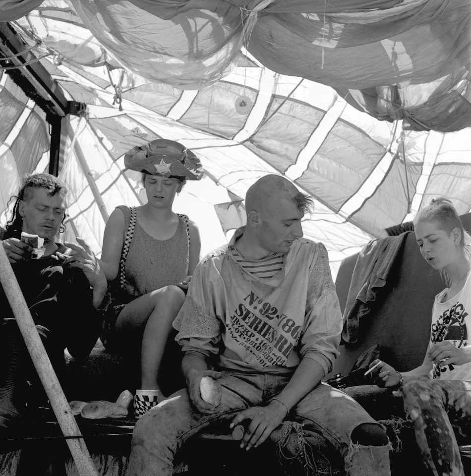  A shot from 1989 shows a group of attendees relaxing with a smoke. Van Morrison and Suzanne Vega attended, despite Suzanne receiving a death threat before festivities kicked off