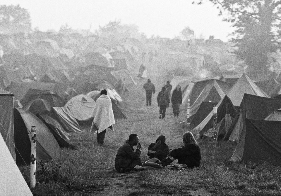  A shot from 1993 shows a cluster of happy campers sat outside their tents. The Orb and Lenny Kravitz headlined this year, with the festival selling out advance tickets by mid-June