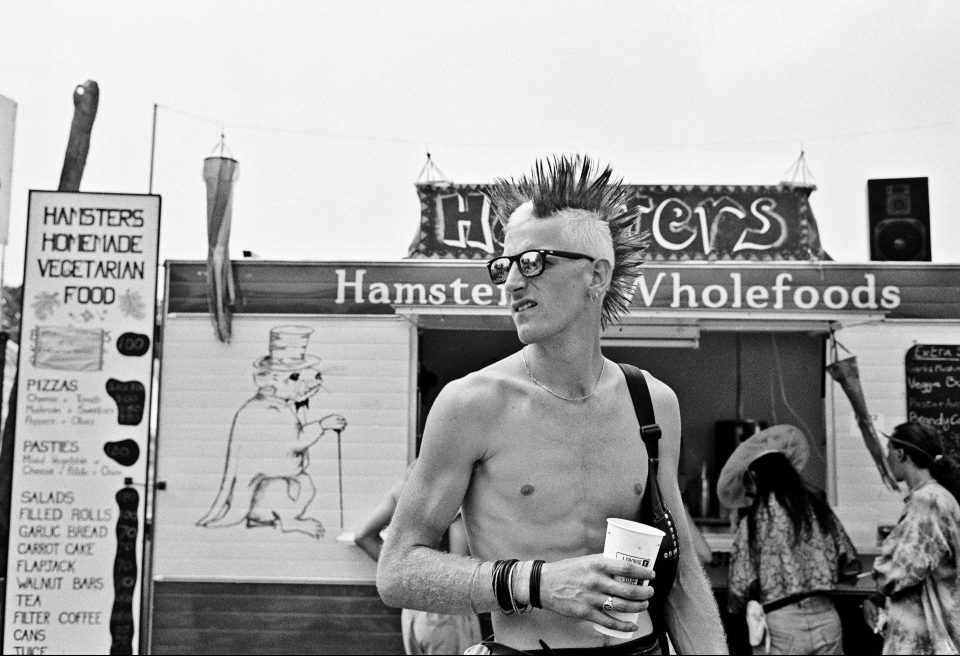  A shot from 1994 shows a reveller with a distinct punk style. In 1994, the Pyramid stage burned down in the early hours of the morning - although a last-minute replacement was, thankfully, provided by a local company