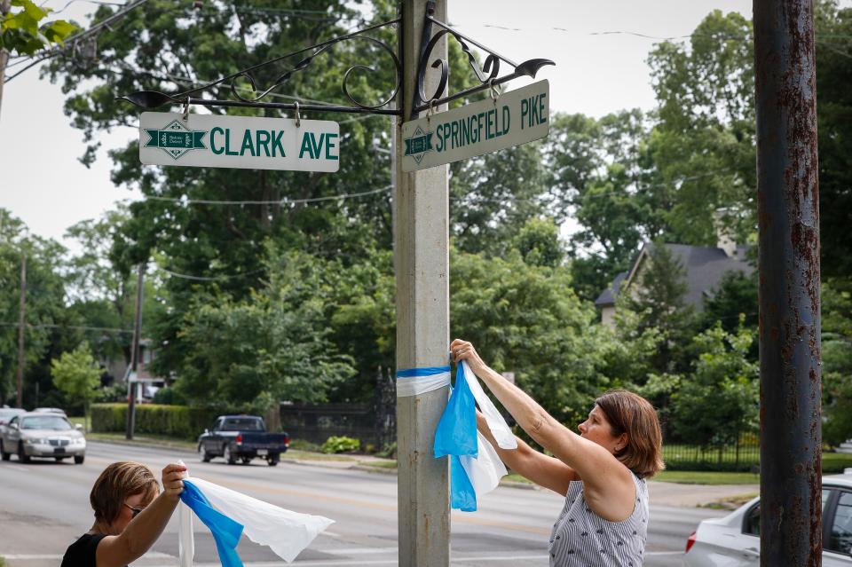  Residents of the northern Cincinnati suburb put up blue-and-white ribbons near the family's home