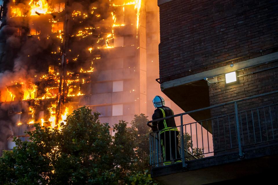  A firefighter watches the nightmarish scene at Grenfell Tower