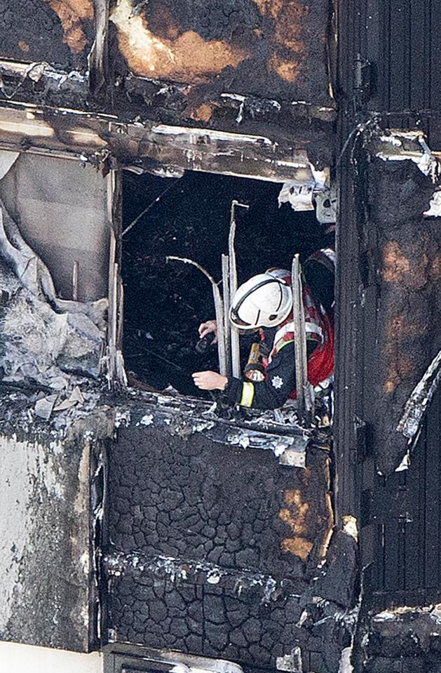  Firefighters were this afternoon pictured inspecting the gutted tower block