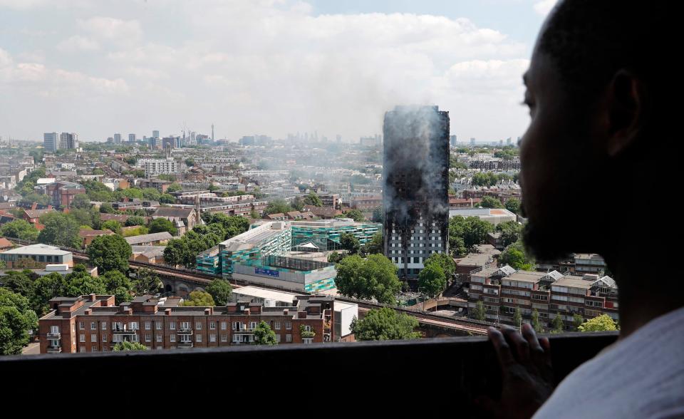  A Londoner watches smoke billowing from Grenfell from a balcony