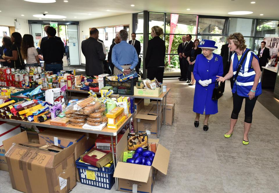  Her Majesty looks at the items donated in the wake of the horrific tragedy