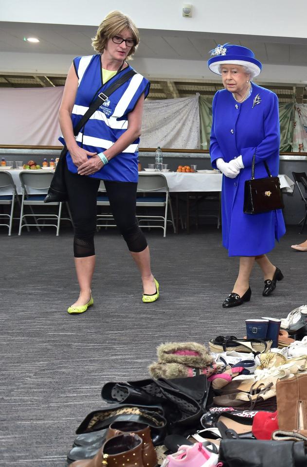  The Queen walked among the piles of donations that have been made since the tragedy