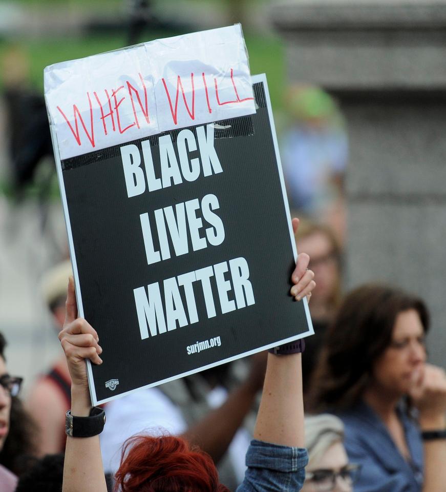  Hundreds of people, some holding Black Lives Matter signs, gathered in the city