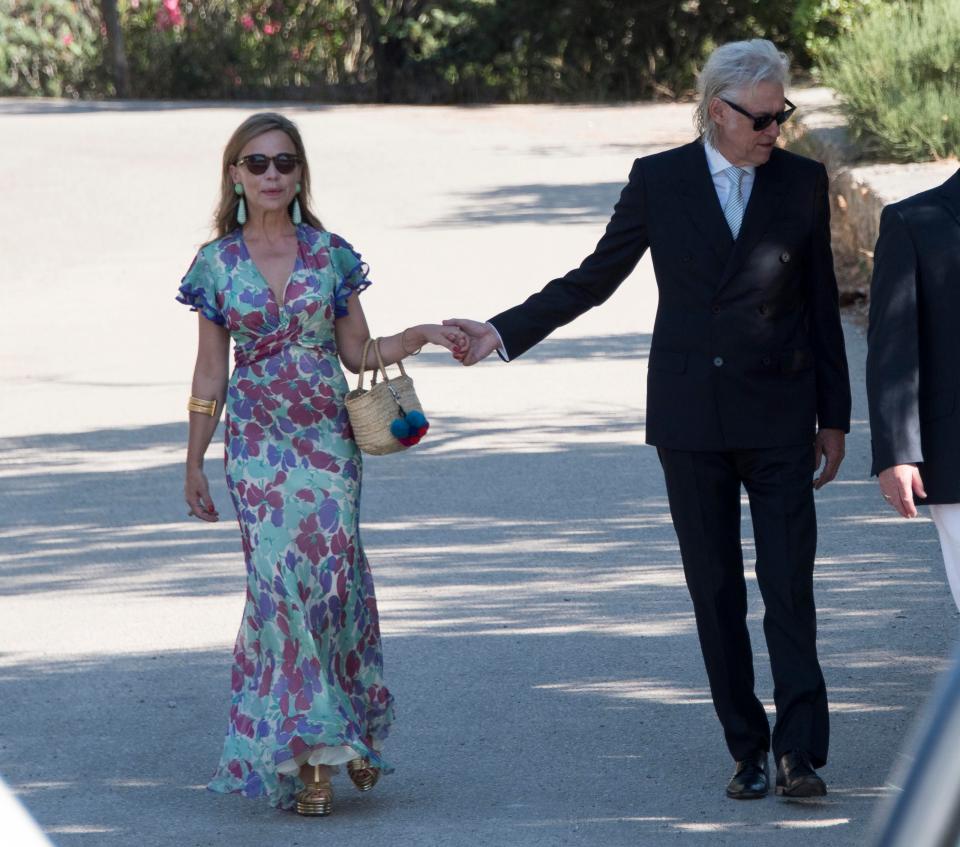  Bob holds hands with Jeanne as they stroll towards the church