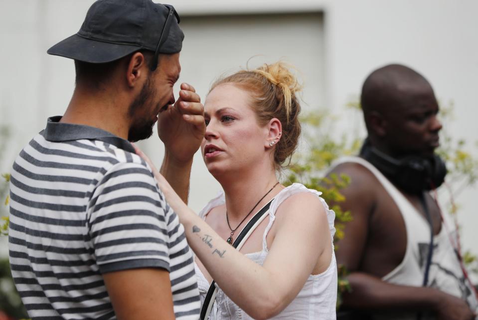  A man cries as he looks at the tributes to the victims and the missing