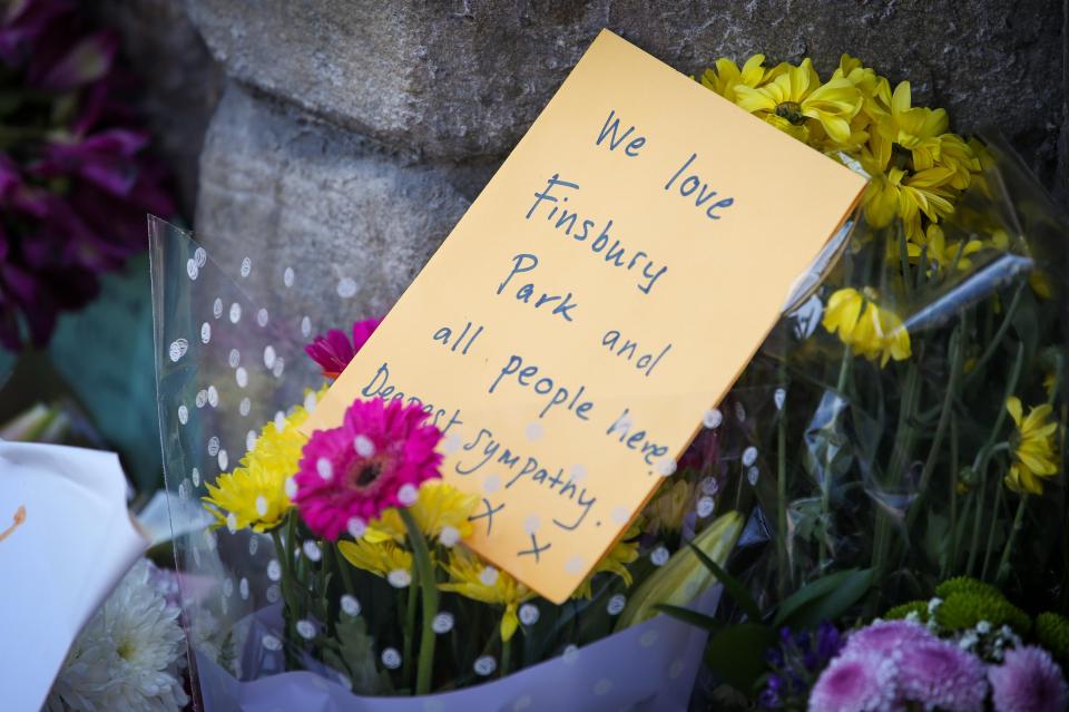  A floral tribute with a message which reads 'We love Finsbury Park and all the people here. Dearest sympathy'