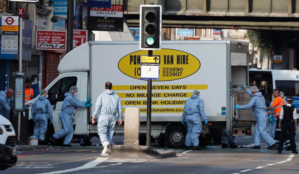  Forensic officers remove the white hire van used in the alleged attack at Finsbury Park as investigations continue